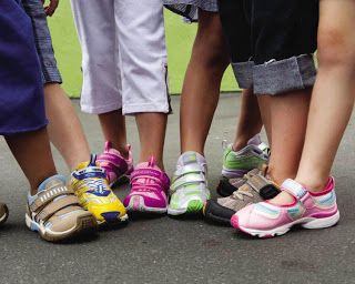 Children receiving new sneakers from the KIC Way Foundation