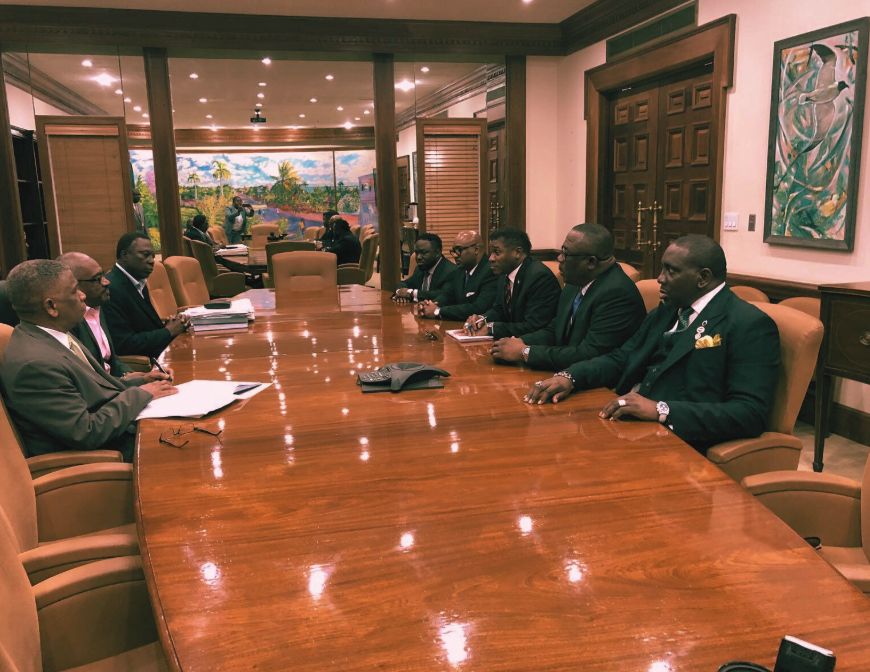 Leaders seated around a council table